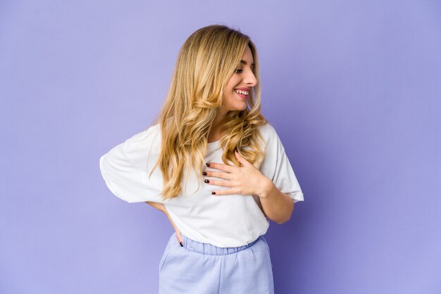 Young caucasian blonde woman expressing emotions isolated