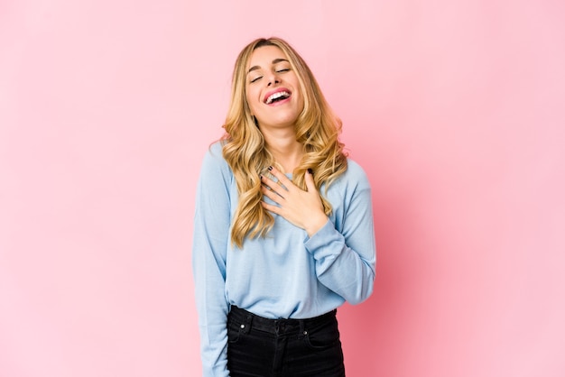 Young caucasian blonde woman laughing and having fun.
