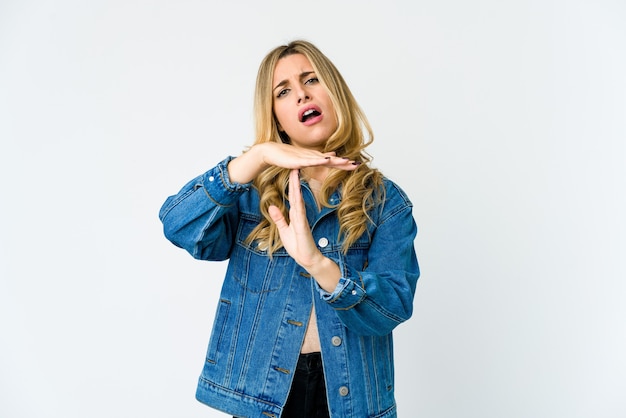 Young caucasian blonde woman showing a timeout gesture.