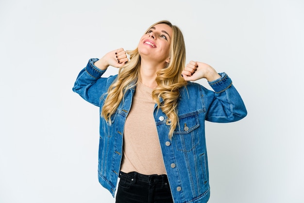 Young caucasian blonde woman stretching arms, relaxed position.