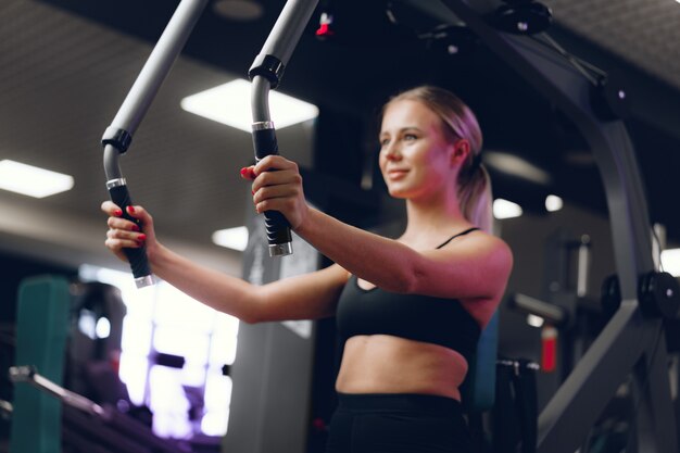 Young caucasian blonde woman training hands in a gym