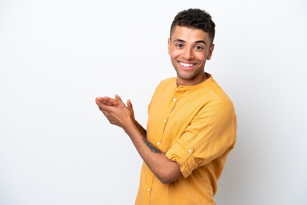 Young caucasian Brazilian man isolated on white background applauding