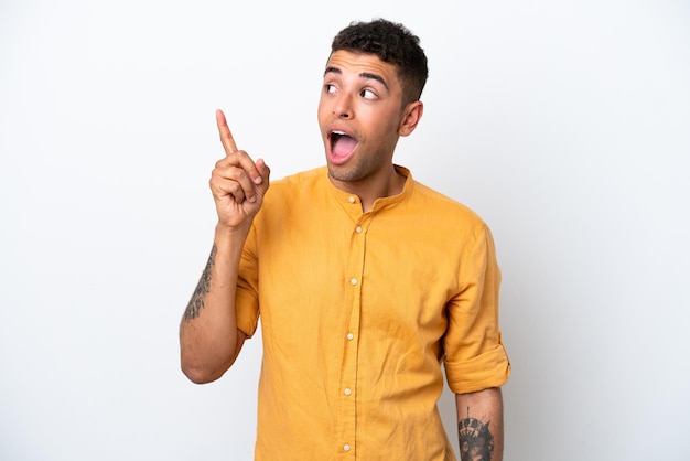 Young caucasian Brazilian man isolated on white background intending to realizes the solution while lifting a finger up