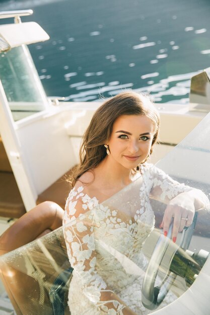 Young caucasian bride on yacht on Como lake in Italy