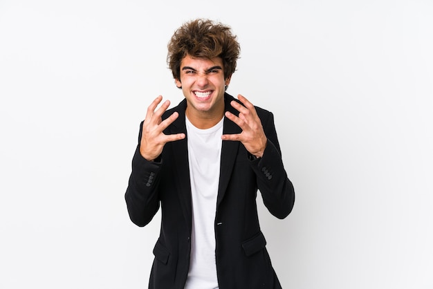 Young caucasian business man against a white surface isolated upset screaming with tense hands.