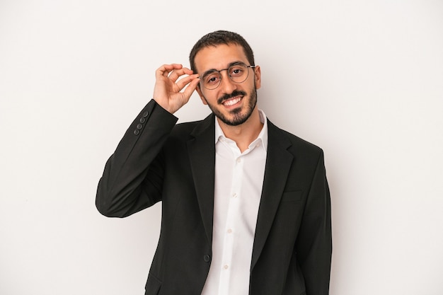 Young caucasian business man isolated on white background excited keeping ok gesture on eye.