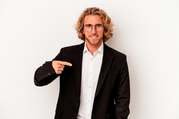 Young caucasian business man isolated on white background person pointing by hand to a shirt copy space, proud and confident