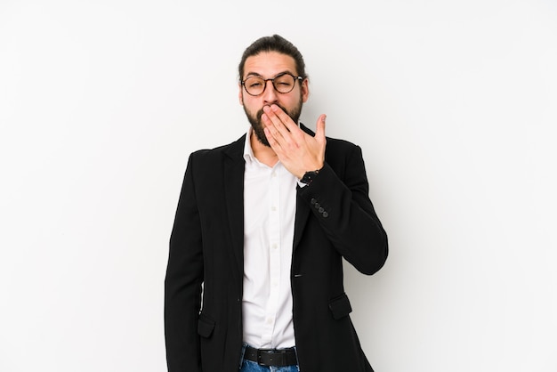 Young caucasian business man on a white wall yawning showing a tired gesture covering mouth with hand.