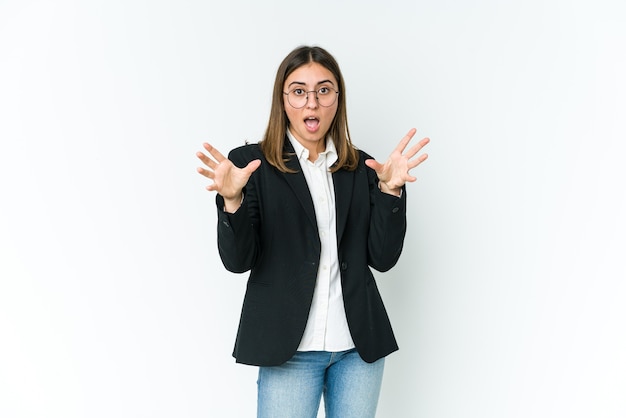 Young caucasian business woman being shocked due to an imminent danger