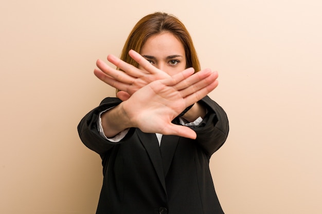 Young caucasian business woman doing a denial gesture