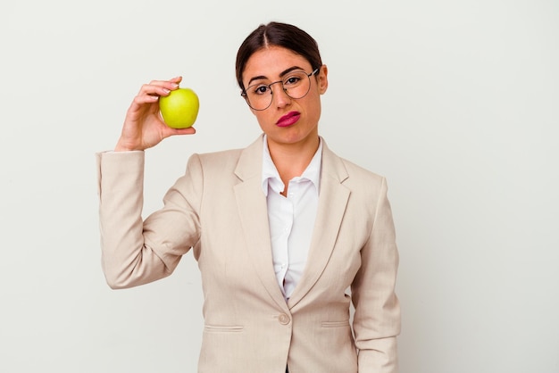 Young caucasian business woman eating an apple isolated