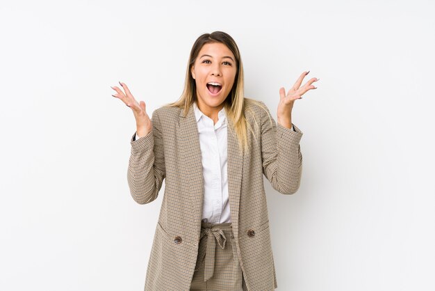 Young caucasian business woman isolated celebrating a victory or success, he is surprised and shocked.