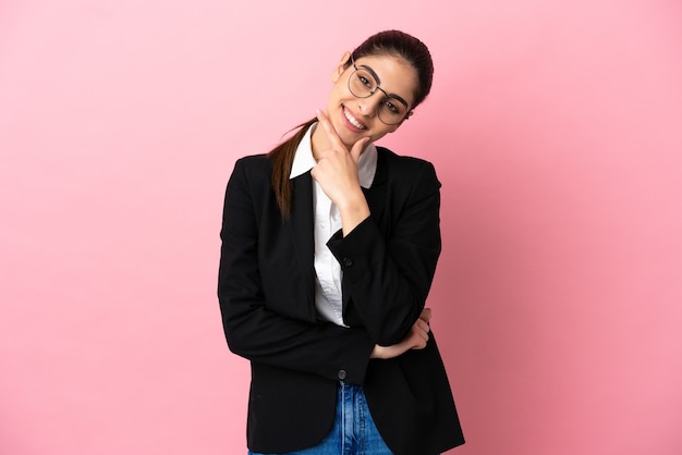 Young caucasian business woman isolated on pink background smiling