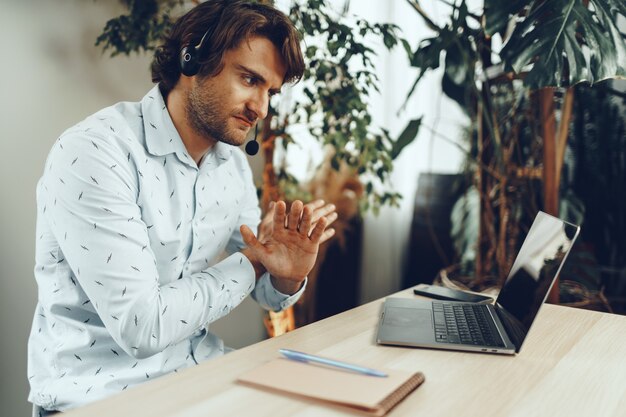 Young caucasian businessman holding video call with clients partners