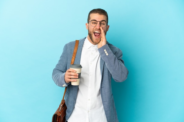 Young caucasian businessman isolated shouting with mouth wide open