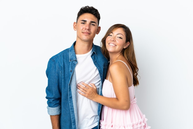 Young caucasian couple on white hugging