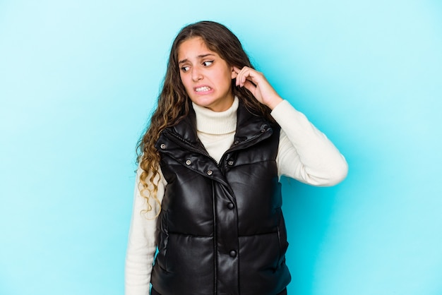 Young caucasian curly hair woman isolated covering ears with hands.