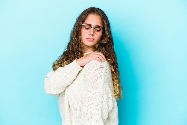 Young caucasian curly hair woman isolated having a shoulder pain.