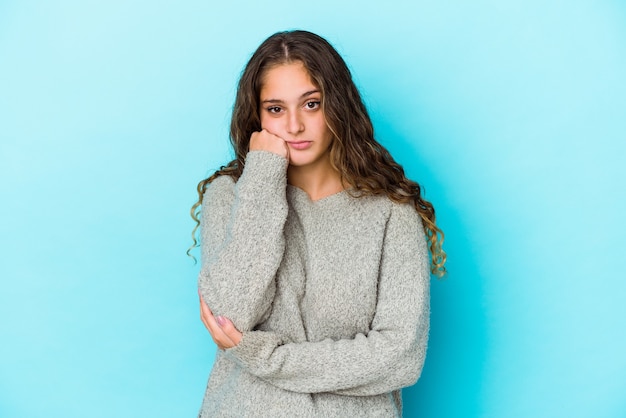 Young caucasian curly hair woman isolated who feels sad and pensive, looking at copy space.