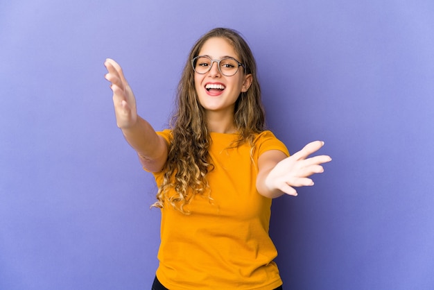 Young caucasian cute woman feels confident giving a hug