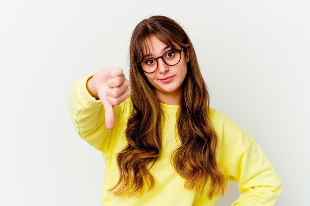 Young caucasian cute woman isolated on white background showing thumb down, disappointment concept.