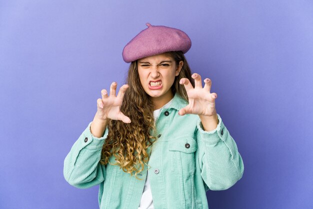 Young caucasian cute woman showing claws imitating a cat, aggressive gesture.