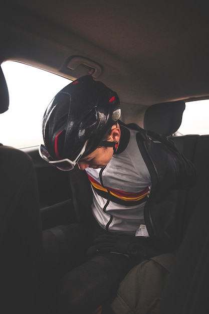 Young caucasian cyclist man getting ready for a ride inside a car.