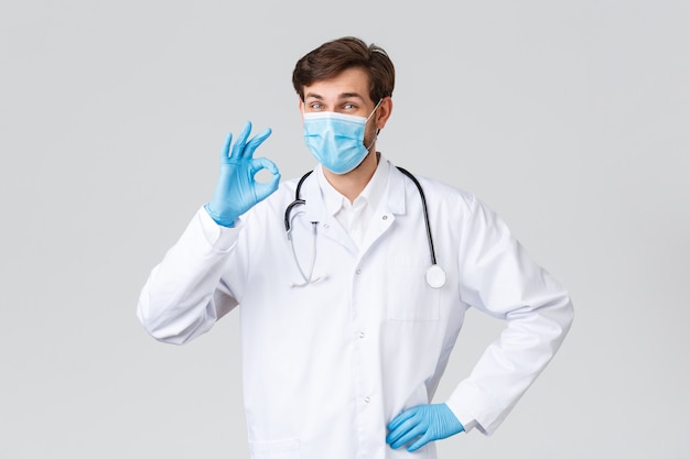 Young caucasian doctor with mask in pandemic virus