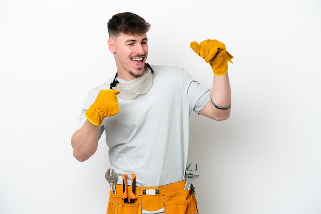 Young caucasian electrician man isolated on white background celebrating a victory