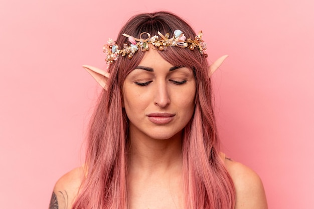 Young caucasian elf woman isolated on pink background