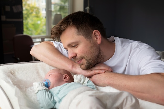 Young caucasian father hugging his newborn daughter