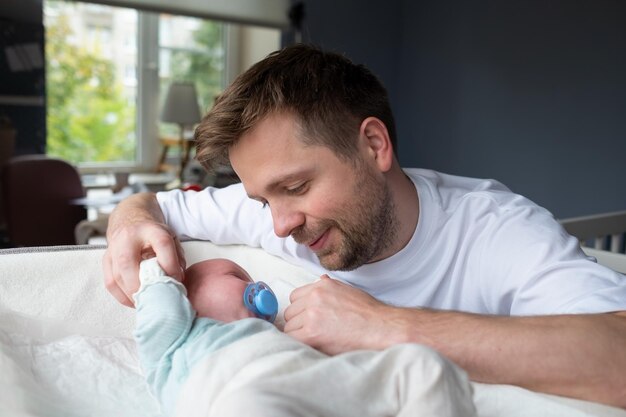 Young caucasian father hugging his newborn daughter