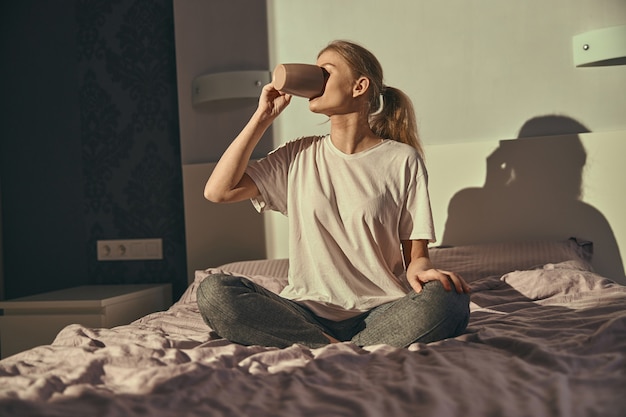 Young caucasian female in bed at the morning relaxing