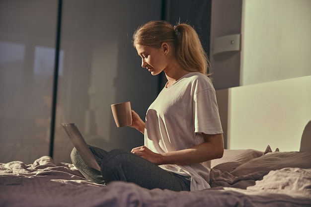 Young caucasian female in bed at the morning relaxing