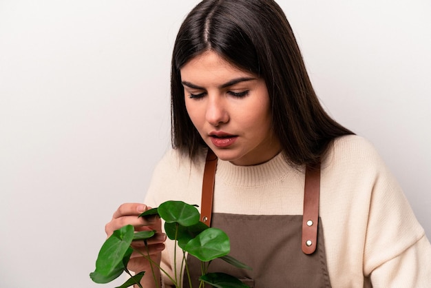 Young caucasian gardener woman working on the table isolated on white background