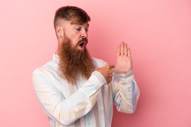 Young caucasian ginger man with long beard isolated on pink background smiling cheerful showing number five with fingers.