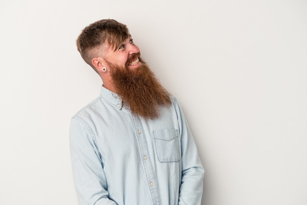 Young caucasian ginger man with long beard isolated on white background relaxed and happy laughing, neck stretched showing teeth.