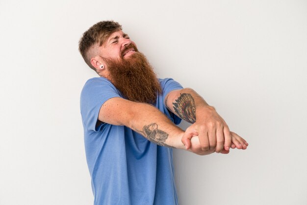 Young caucasian ginger man with long beard isolated on white background stretching arms, relaxed position.