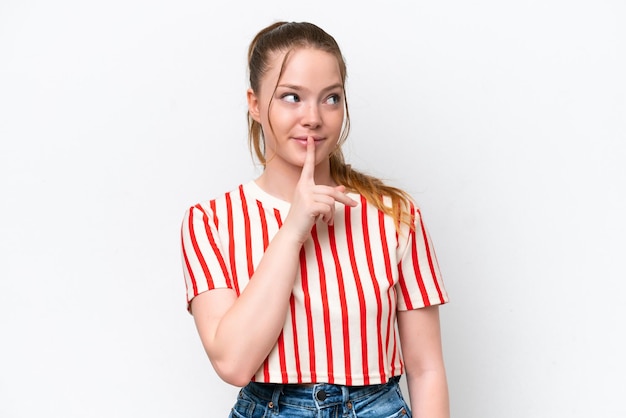 Young caucasian girl isolated on white background showing a sign of silence gesture putting finger in mouth