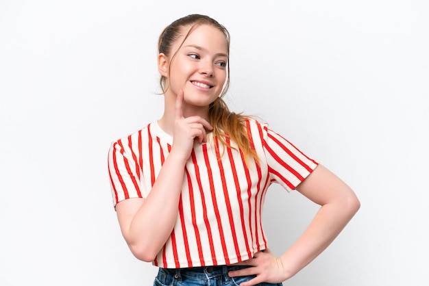 Young caucasian girl isolated on white background thinking an idea while looking up