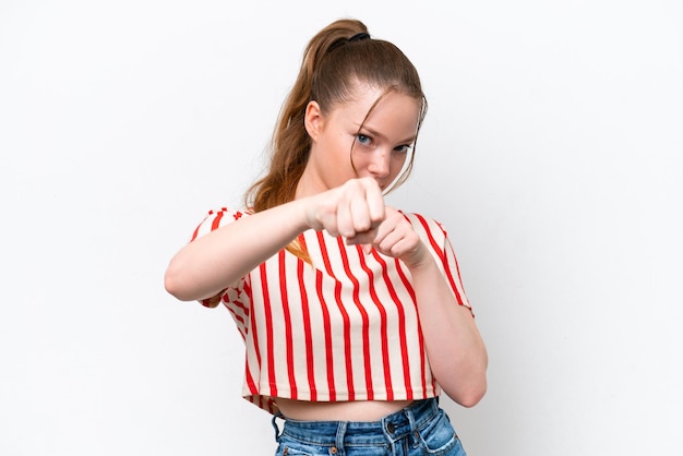 Young caucasian girl isolated on white background with fighting gesture