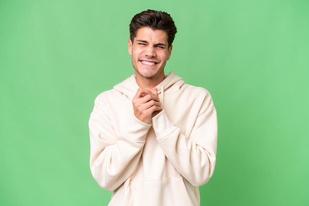 Young caucasian handsome man over isolated background laughing