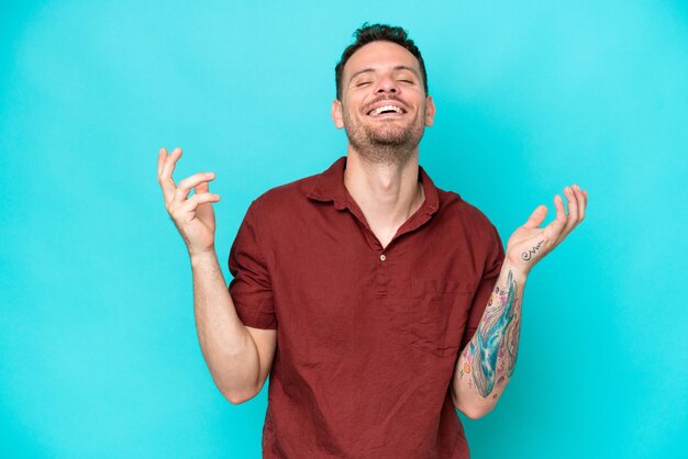 Young caucasian handsome man isolated on blue background smiling a lot