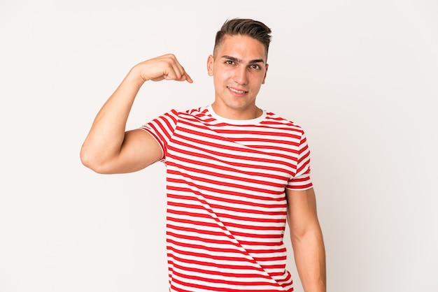 Young caucasian handsome man isolated person pointing by hand to a shirt copy space, proud and confident