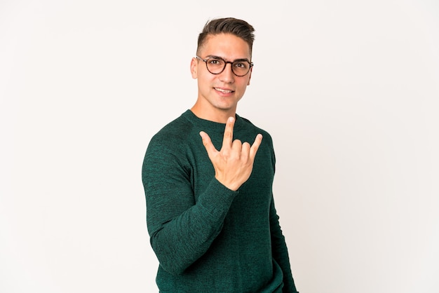 Young caucasian handsome man isolated showing rock gesture with fingers