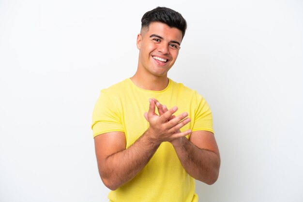 Young caucasian handsome man isolated on white background applauding after presentation in a conference