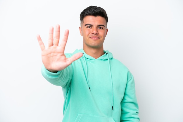 Young caucasian handsome man isolated on white background counting five with fingers