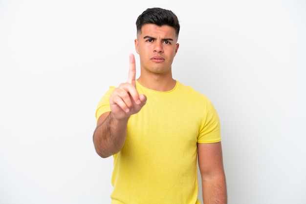 Young caucasian handsome man isolated on white background counting one with serious expression