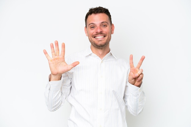 Young caucasian handsome man isolated on white background counting seven with fingers