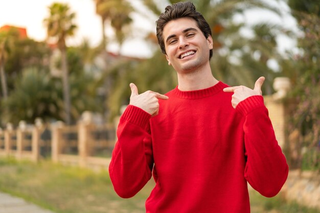 Young caucasian handsome man isolated on white background happy and counting three with fingers